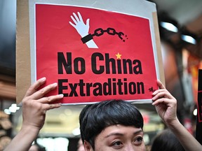 A demonstrator holds a placard during a protest in Hong Kong against a controversial move by the government to allow extraditions to the Chinese mainland, on April 28, 2019.