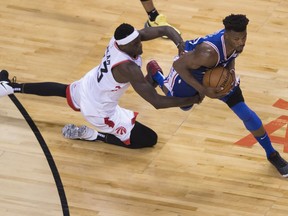 Toronto Raptors forward Pascal Siakam (43) fouls Philadelphia 76ers guard Jimmy Butler (23) during second half, second round NBA basketball playoff action in Toronto, on Monday, April 29, 2019.
