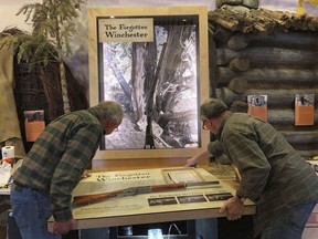 In this April 2019 photo workers for the design company DiVittorio and Associations help install the new exhibit at the visitor center at Great Basin National Park in Baker, Nev. for the "Forgotten Winchester," an 1882 rifle that was discovered leaning against a tree in 2014. (National Park Service via AP)