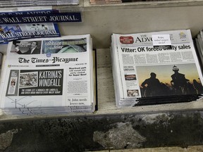 FILE - In this Thursday, Sept. 27, 2012 file photo, free introductory copies of the Baton Rouge Advocate's new New Orleans edition, right, are seen next to copies of the New Orleans Times-Picayune at Lakeside News in the New Orleans suburb of Metairie, La. The owners of Louisiana's The Advocate newspaper have purchased The Times-Picayune in New Orleans from Advance Local Media. The Advocate announced the purchase on its website Thursday, May 2, 2019.