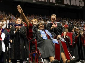 This photo provided by UA Strategic Communications Autherine Lucy Foster acknowledges the crowd as she receives a an honorary doctoral degree during a commencement exercise at The University of Alabama on Friday, May 3, 2019 in Tuscaloosa, Ala.  The university bestowed the honorary doctorate degree to Foster, the first African American to attend the university.