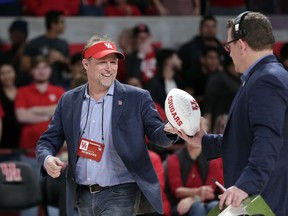FILE - In this Jan. 2, 2019, file photo, new Houston NCAA college football coach Dana Holgorsen get an autographed football to toss to fans during halftime of a basketball game between Houston and Tulsa, in Houston. The 2019 Most Likely to Succeed list ranks the new hires in FBS.