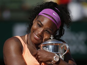 FILE - In this June 6, 2015, file photo, Serena Williams holds the trophy after winning the final of the French Open tennis tournament against Lucie Safarova of the Czech Republic, at the Roland Garros stadium in Paris, France. Welcome back to Paris, Serena Williams. The tennis world can't wait to find out exactly how that bothersome left knee is holding up.