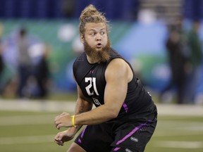 FILE - In this March 2, 2018, file photo, Washington State offensive lineman Cole Madison runs a drill at the NFL football scouting combine in Indianapolis. When the Green Bay Packers used a fifth-round draft pick on Madison last year, there was optimism that the former Washington State standout would be able to fill an opening at right guard. Madison didn't report for training camp. He put football on hold to focus on his life. After sitting out his entire rookie season, Madison joined the team for the start of offseason workouts in April and was expected to be on the field this weekend for the Packers' rookie camp.