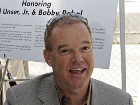 FILE - In this April 16, 2009, file photo, Al Unser Jr. speaks as he signs autographs after he was inducted into the Long Beach Motorsports Walk of Fame in Long Beach, Calif. Retired two-time Indianapolis 500 winner Al Unser Jr. has been arrested in central Indiana and charged with operating a vehicle while intoxicated. The Indianapolis Star reports from police records that the 57-year-old Unser was stopped early Monday, May 20, 2019, in Avon, just west of Indianapolis. He was jailed about 3:20 a.m. in Hendricks County. The Associated Press was unable Monday to reach Unser for comment.