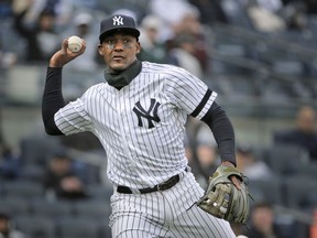 FILE - In this March 31, 2019, file photo, New York Yankees' Miguel Andujar throws to first base during the second inning of the team's baseball game against the Baltimore Orioles at Yankee Stadium in New York. Andújar is set to come off the injured list Saturday, and the team hopes infielder DJ LeMahieu will return to the lineup that day as well. Yankees outfielder Clint Frazier is scheduled to follow on Monday, when center fielder Aaron Hicks could begin a minor league rehab assignment. With 13 players still on the injured list, manager Aaron Boone gave a long rundown of medical status reports Friday, May 3, before New York opened a homestand against the major league-leading Minnesota Twins.