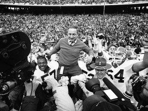 FILE - In this Jan. 2, 1984, file photo, Georgia coach Vince Dooley is carried off the field after Georgia beat Texas 10-9 in the Cotton Bowl in Dallas. Georgia is planning to honor Hall of Fame former coach Vince Dooley by naming the field at Sanford Stadium in his honor. A ceremony has been planned for Georgia's 2019 opening game on Sept. 7 against Murray State to dedicate Dooley Field at Sanford Stadium.