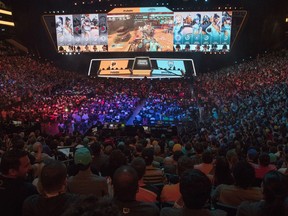 FILE - In this July 28, 2018, file photo, fans watch the competition between the Philadelphia Fusion and the London Spitfire during the Overwatch League Grand Finals, at Barclays Center in the Brooklyn borough of New York. Overwatch League Commissioner Nate Nanzer is leaving the competitive video game circuit to oversee esports competition for Fortnite publisher Epic Games. Nanzer tweeted Friday night, May 24, 2019, he was moving on from Activision Blizzard, the company behind the Overwatch game and league, for a "new opportunity." He didn't provide further details or a firm timeline except to say he'll be leaving "soon." Epic Games tells ESPN they will hire Nanzer to help turn the world's most popular video game into a viable esport.