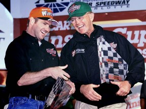 FILE - In this Wednesday, Oct. 6, 1999 file photo, Bobby Labonte, left, of Corpus Christi, Texas celebrates in victory lane with team owner Joe Gibbs after winning the pole position for Sunday's UAW-GM 500 race at the Lowe's Motor Speedway in Concord, N.C. Tony Stewart headlines a Joe Gibbs racing trio that has been elected to the NASCAR Hall of Fame. The three-time Cup Series champion will be inducted alongside car owner Joe Gibbs and former teammate Bobby Labonte.