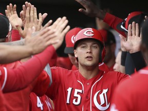 FILE - In this Monday, March 11, 2019 file photo, Cincinnati Reds' Nick Senzel (15) celebrates his run scored against the Cleveland Indians during the second inning of a spring training baseball game in Goodyear, Ariz. The Cincinnati Reds could bring up top prospect Nick Senzel before the Friday, May 3, 2019 game against San Francisco, putting the 23-year-old outfielder in position to make his major league debut against the Giants.