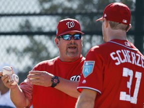 FILE - In this Feb. 17, 2018, file photo, Washington Nationals pitching coach Derek Lilliquist, left, talks with pitcher Max Scherzer during baseball spring training in West Palm Beach, Fla. The Nationals have fired Lilliquist. Minor league pitching coordinator Paul Menhart has been promoted to replace Lilliquist. General manager Mike Rizzo made the announcement Thursday, May 2, moments after the Nationals defeated the St. Louis Cardinals 2-1.