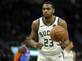 FILE - In this April 10, 2019, file photo, Milwaukee Bucks' Sterling Brown prepares to shoot a free throw during the second half of an NBA basketball game against the Oklahoma City Thunder in Milwaukee. The city of Milwaukee wants to offer Bucks guard Sterling Brown $400,000 to settle his lawsuit alleging that police used excessive force when they used a stun gun to arrest him over a parking violation. The Journal Sentinel reports that the city's Common Council has scheduled a June 10 vote on whether to extend the offer. City attorneys are asking officials to authorize it.