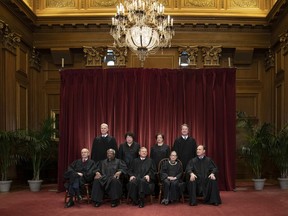 FILE - In this Nov. 30, 2018, file photo, the justices of the U.S. Supreme Court gather for a formal group portrait to include a new Associate Justice, top row, far right, at the Supreme Court Building in Washington. Seated from left: Associate Justice Stephen Breyer, Associate Justice Clarence Thomas, Chief Justice of the United States John G. Roberts, Associate Justice Ruth Bader Ginsburg and Associate Justice Samuel Alito Jr. Standing behind from left: Associate Justice Neil Gorsuch, Associate Justice Sonia Sotomayor, Associate Justice Elena Kagan and Associate Justice Brett M. Kavanaugh. Alabama's virtual ban on abortion is the latest and most far-reaching state law seemingly designed to prod the Supreme Court to reconsider a constitutional right it announced 46 years ago in the landmark Roe v. Wade decision.