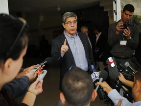 FILE - In this Dec. 12, 2018, file photo, Cuba's Director-General of U.S. Affairs Carlos Fernandez de Cossio makes a statement to reporters, in Havana, Cuba. De Cossio says his nation has no troops in Venezuela but it maintains the right to military and intelligence cooperation with its ally.