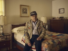 In this May 14, 2019, photo, World War II U.S. veteran Frank DeVita, who took part in the D-Day battle, poses for a picture at his home in Bridgewater, N.J. This June he'll make his 12th trip back to Normandy. He likes to bring people with him so they'll know what happened there.