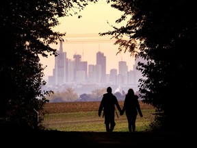 FILE - In this Oct. 21, 2018, file photo, a couple walks through a forest with the Frankfurt skyline in background near Frankfurt, Germany. Development that's led to loss of habitat, climate change, overfishing, pollution and invasive species is causing a biodiversity crisis, scientists say in a new United Nations science report released Monday, May 6, 2019.