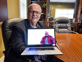 In this Wednesday, May 8, 2019, photo, Allen Henderson, General Manager of HIS Radio Station in Greenville, S.C., speaks via Skype to his brother Andre Gantois who is in France. Henderson took a DNA test on a whim, because the company had a special offer on its prices and learned he had a half-brother in France.