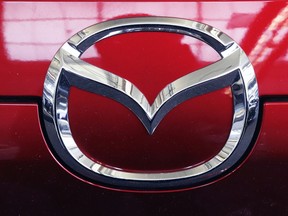 FILE - This Feb. 14, 2019, file photo shows the Mazda logo at the 2019 Pittsburgh International Auto Show in Pittsburgh. U.S. safety regulators on Monday, May 6, are investigating reports that side curtain air bags can inflate for no reason on some Mazda CX-9 large SUVs. The probe covers CX-9s from the 2010 through 2013 model years.