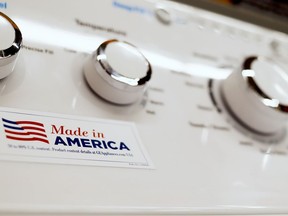 In this May 9, 2019, photo a General Electric washing machine with a label advertising it was made in America is displayed in retail stores in Cranberry Township, Pa. China has announced tariff hikes on $60 billion of U.S. goods in retaliation for President Donald Trump's escalation of a fight over technology and other trade disputes. The Finance Ministry said Monday, May 13, the penalty duties of 5% to 25% on hundreds of U.S. products including batteries, spinach and coffee take effect June 1.