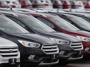 FILE- In this Feb. 17, 2019, file photo rows of unsold 2019 Escape sports-utility vehicles sit in long rows at a Ford dealership in Broomfield, Colo. On Wednesday, May 15, the Commerce Department releases U.S. retail sales data for April.