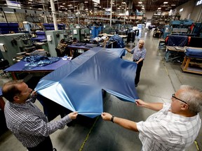 FILE - In this July 5, 2018, file photo workers assemble the Afloat water mattresses at the factory in Corona, Calif. On Wednesday, May 15, 2019, the Federal Reserve reports on U.S. industrial production for April.