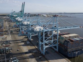 FILE - In this May 10, 2019, file photo a container ship is unloaded at the Virginia International Gateway terminal in Norfolk, Va. On Thursday, May 30, the Commerce Department issues the second estimate of how the U.S. economy performed in the January-March quarter.