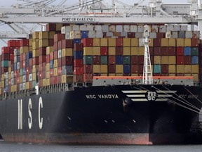 FILE- In this Jan. 28, 2019, file photo a container ship is unloaded at the Port of Oakland in Oakland, Calif. On Thursday, May 2, the Labor Department issues revised data on productivity in the first quarter.