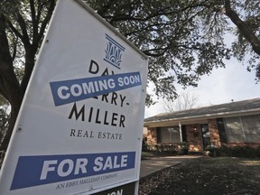 FILE- In this Feb. 20, 2019, file photo a coming soon for sale sign sits in front of a home in the Dallas suburb of Richardson, Texas. On Thursday, May 2, Freddie Mac reports on this week's average U.S. mortgage rates.