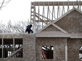 FILE - In this Jan. 23, 2019, file photo, construction workers build new housing in Salisbury, Mass. On Thursday, May 16, the Commerce Department reports on U.S. home construction in April.