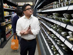 FILE - In this May 7, 2019, file photo a customer shops in a newly-opened Amazon Go store in New York. On Friday, May 10, the Labor Department reports on U.S. consumer prices for March.