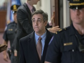FILE - In this March 6, 2019 photo, Michael Cohen, President Donald Trump's former personal lawyer departs the Capitol in Washington. Prosecutors aren't quite finished investigating campaign finance violations by Cohen. A federal judge in New York agreed Tuesday, May 21 to keep search warrant materials related to the investigation under seal until at least mid-July after prosecutors submitted a letter explaining that the probe is still ongoing. Cohen is serving a three-year prison sentence after admitting paying off two women who claimed they had affairs with Trump.