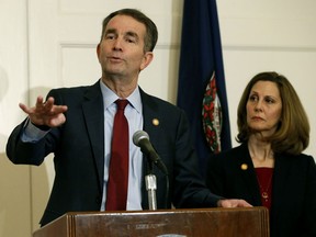 FILE - In this Feb. 2, 2019 file photo, Virginia Gov. Ralph Northam, left, gestures as his wife, Pam, listens during a news conference in the Governors Mansion at the Capitol in Richmond, Va. A law firm has completed its investigation into how a racist photo appeared on a yearbook page for Northam. Eastern Virginia Medical School said in a statement Tuesday, May 21 that the findings of the investigation will be announced at a press conference on Wednesday, May 22. Northam's profile in the 1984 yearbook includes a photo of a man in blackface standing next to someone in Ku Klux Klan clothing. Northam denies being in the photo, which nearly ended his political career in February.
