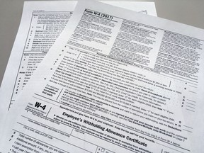 FILE - This Feb. 1, 2018 file photo shows an IRS W-4 form in New York. On Friday, May 31, 2019, the IRS is expected to release a proposed update to the form. Experts say that while it will be much more accurate, it will also be much more difficult.