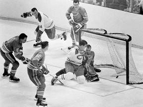 FILE - Intis May 7, 1968, file photo, Montreal Canadiens' Serge Savard is about to land in the lap of St. Louis Blues' goalie Glenn Hall as the puck spins into the net for the winning goal in the NHL Stanley Cup finals at St. Louis, Mo. The Blues made the Stanley Cup Finals in their first three seasons but lost in sweeps to the Montreal Canadiens in 1968 and 1969 and the Bruins in 1970. (AP Photo/File)