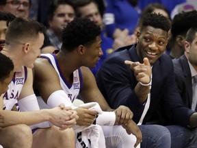 FILE - In this Feb. 2, 2019, file photo, Kansas forward Silvio De Sousa, right, points to teammates during the second half of an NCAA college basketball game against Texas Tech in Lawrence, Kan. De Sousa will be eligible to play next season after the NCAA's reinstatement committee agreed Friday with an appeal filed by the school.