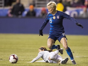 FILE - In this Feb. 27, 2019, file photo, United States' Megan Rapinoe, right, and Japan's Risa Shimizu, left, go after the ball during the first half of SheBelieves Cup soccer match in Chester, Pa.
