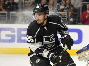 FILE - In this Oct. 16, 2014, file photo, Los Angeles Kings defenseman Slava Voynov, of Russia, skates during the third period of an NHL hockey game against the St. Louis Blues in Los Angeles. An arbitrator has upheld Voynov's one-season suspension by the NHL but is giving him credit for serving half of it in 2018-19. Commissioner Gary Bettman suspended the former Los Angeles Kings defenseman for the 2019-20 season and 2020 playoffs after it determined he committed acts of domestic violence. The NHL Players Association appealed the ruling.