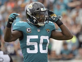 FILE - In this Sept. 16, 2018, file photo, Jacksonville Jaguars linebacker Telvin Smith (50) gestures to fans during the first half of an NFL football game against the New England Patriots in Jacksonville, Fla. Smith, the team's leading tackler the last two seasons and a Pro Bowl selection in 2017, is stepping away from football to "give this time back to myself, my family & my health."