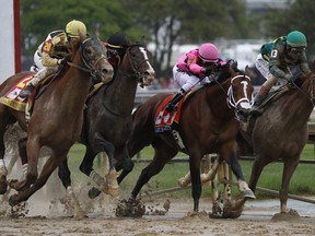 FILE - In this May 4, 2019, file photo, from left, Country House, ridden by Flavien Prat; War of Will, ridden by Tyler Gaffalione; Maximum Security, ridden by Luis Saez; and Code of Honor, ridden by John Velazquez; head down the mainstretch during the 145th running of the Kentucky Derby horse race at Churchill Downs in Louisville, Ky. Maximum Security owner Gary West said in a statement released Friday, May 17, 2019, he'll pay each of the owners $5 million apiece if Country House, War of Will, Long Range Toddy or Bodexpress finish ahead of Maximum Security in the next race against him through the end of the year.