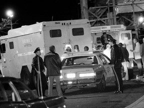 FILE - In this Oct. 21, 1981, file photo, police are at the scene of a Brinks armored truck robbery at the Nanuet Mall in Nanuet, N.Y., where multiple Nyack police officers and a Brinks guard were killed earlier during the robbery. State prison officials say, Judith Clark is a former Weather Underground member who has served 35 years of a 75-year-to-life sentence for her role in the robbery, was released Friday, May 10, 2019, from Bedford Hills Correctional Facility in Westchester County. She became eligible for parole consideration after Gov. Andrew Cuomo granted her clemency in 2016, citing her many achievements in prison.
