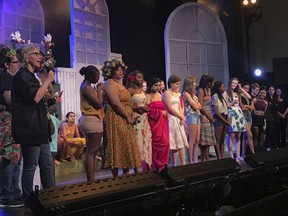 This image released by Madeline Michel shows Monticello Drama director Michel, foreground left, on stage with Monticello High School students in Charlottesville, Va. Michel will be the recipient of the  2019 Excellence in Theatre Education Award on June 9 at the Tony Awards in New York City.  (Madeline Michel via AP)