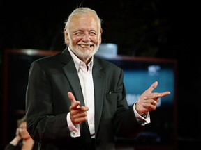 FILE - In this Sept. 9, 2009, file photo, director George Romero arrives for the screening of the film "Survival Of The Dead" at the 66th edition of the Venice Film Festival in Venice, Italy. The University of Pittsburgh is getting a spooky addition: the archives of late iconic filmmaker George A. Romero. His horror flicks date back to the 1968 film "Night of the Living Dead," and many consider him the godfather of zombie cinema. The archives will be available to scholars, students and filmmakers and include the original annotated "Night of the Living Dead" script and a foam latex zombie head.