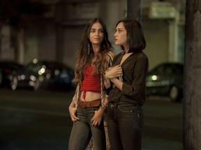 This image released by Starz shows Melissa Barrera, left, and Mishel Prada from the series "Vida," a drama that follows two Mexican American sisters battling gentrification and the aftermath of their mother's death.