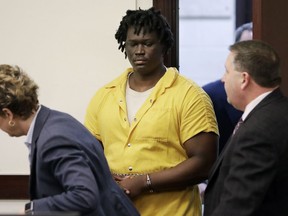 FILE - In this Feb. 20, 2019, file photo, Emanuel Kidega Samson, center, enters the courtroom for a hearing in Nashville, Tenn. Prosecutors have said they're seeking life without parole for 27-year-old Samson, accused of fatally shooting a woman and wounding several people at a Nashville church. His trial is slated to begin Monday, May 20.