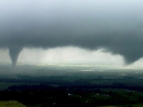 This image made from video provided by KWTV-KOTV shows two funnel clouds formed in Crescent, Okla., Monday, May 20, 2019. An intense storm system that weather forecasters labeled "particularly dangerous" swept through the Southern Plains Monday, spawning a few tornadoes that caused some damage and a deluge of rain but no reports of injuries. (KWTV-KOTV via AP)