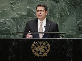 FILE - In this Sept. 26, 2018, file photo, Honduran President Juan Orlando Hernandez addresses the 73rd session of the United Nations General Assembly at the United Nations headquarters. Recently unsealed testimony shows that a brother of the Honduran president admitted to U.S. federal agents that he'd accepted presents from violent drug traffickers he'd known for years and once asked Honduran officials about money the government allegedly owed the traffickers.