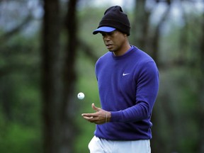 Tiger Woods flips his ball as he walks along the ninth green during a practice round for the PGA Championship golf tournament, Monday, May 13, 2019, in Farmingdale, N.Y.