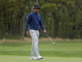 Tiger Woods walks along the ninth green during a practice round for the PGA Championship golf tournament, Monday, May 13, 2019, in Farmingdale, N.Y.