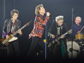 FILE - In this Oct. 22, 2017, file photo from left, Ronnie Wood, Mick Jagger, Keith Richards and Charlie Watts of the Rolling Stones perform during the concert of their "No Filter" Europe Tour 2017 at U Arena in Nanterre, outside Paris. The Rolling Stones are ready to get back on the road after postponing their North American tour because Mick Jagger needed medical treatment, reportedly for a heart valve issue. The rockers on Thursday, May 16, 2019, announced the No Filter tour will kick off in Chicago with two shows on June 21 and 25.