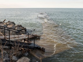 FILE - In this April 20, 2017, file photo, Lake Ontario waters float over the pier at the corner of Ontario and Lake Streets in Wilson N.Y. New York Gov. Andrew Cuomo says the state is preparing for a "worst-case scenario" as water levels again rise along Lake Ontario. Cuomo says flooding from heavy rain and snow melt is "a real possibility," so the state is providing thousands of sandbags and putting members of the New York National Guard on standby.